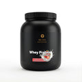 Schwarze Dose des Whey Protein Strawberry von THE VITAL MANUFACTURE, 1000g Inhalt, mit Erdbeer-Grafik und Angabe von 23g Protein pro Portion.